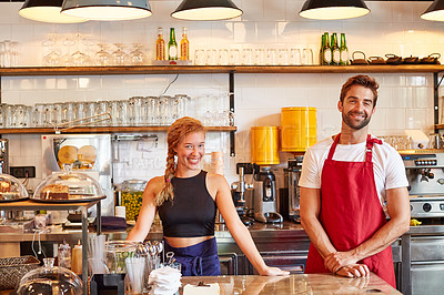Buy stock photo Shot of a confident man and woman working together in a coffee shop