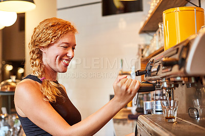 Buy stock photo Shot of a female barista on duty in a coffee shop
