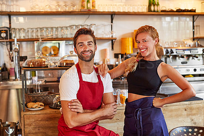 Buy stock photo Shot of a confident man and woman working together in a coffee shop