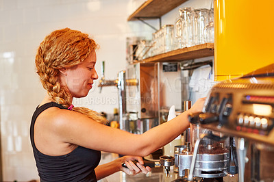 Buy stock photo Shot of a female barista on duty in a coffee shop