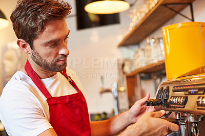Buy stock photo Shot of a barista busy with a coffee machine