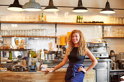 Buy stock photo Shot of a female barista on duty in a coffee shop
