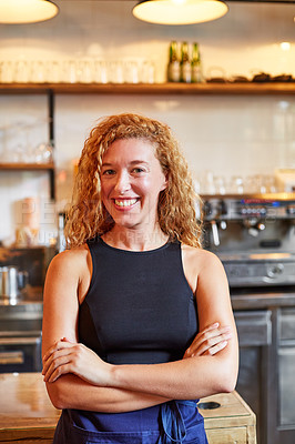Buy stock photo Shot of a female barista on duty in a coffee shop