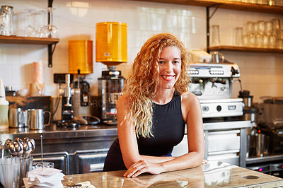 Buy stock photo Shot of a female barista on duty in a coffee shop