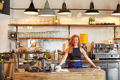Buy stock photo Shot of a female barista on duty in a coffee shop
