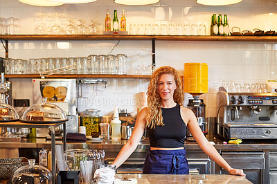 Buy stock photo Shot of a female barista on duty in a coffee shop
