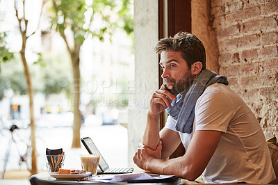 Buy stock photo Cropped shot of a handsome young man sitting in a coffee shop