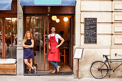 Buy stock photo Shot of co-owners standing outside their coffee shop