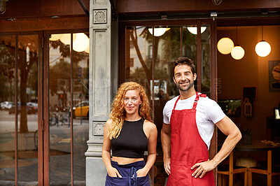 Buy stock photo Shot of co-owners standing outside their coffee shop