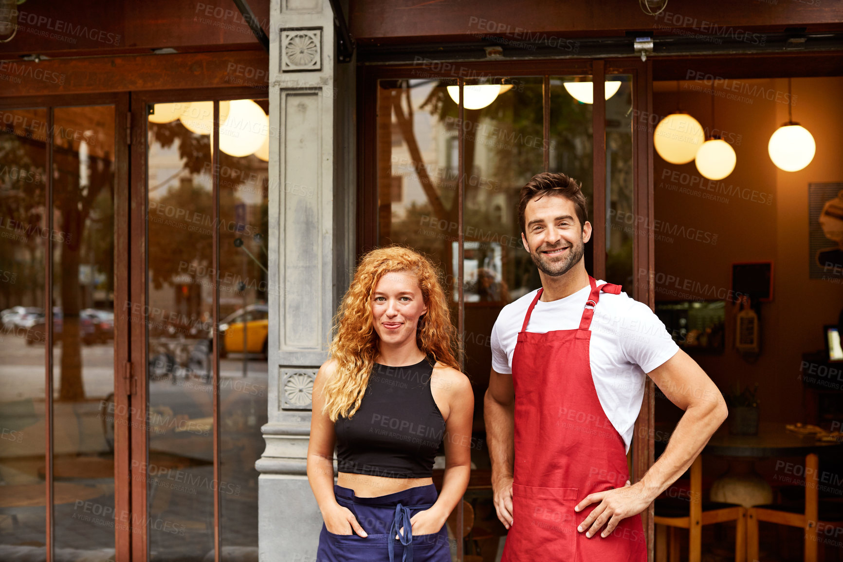 Buy stock photo Shot of co-owners standing outside their coffee shop
