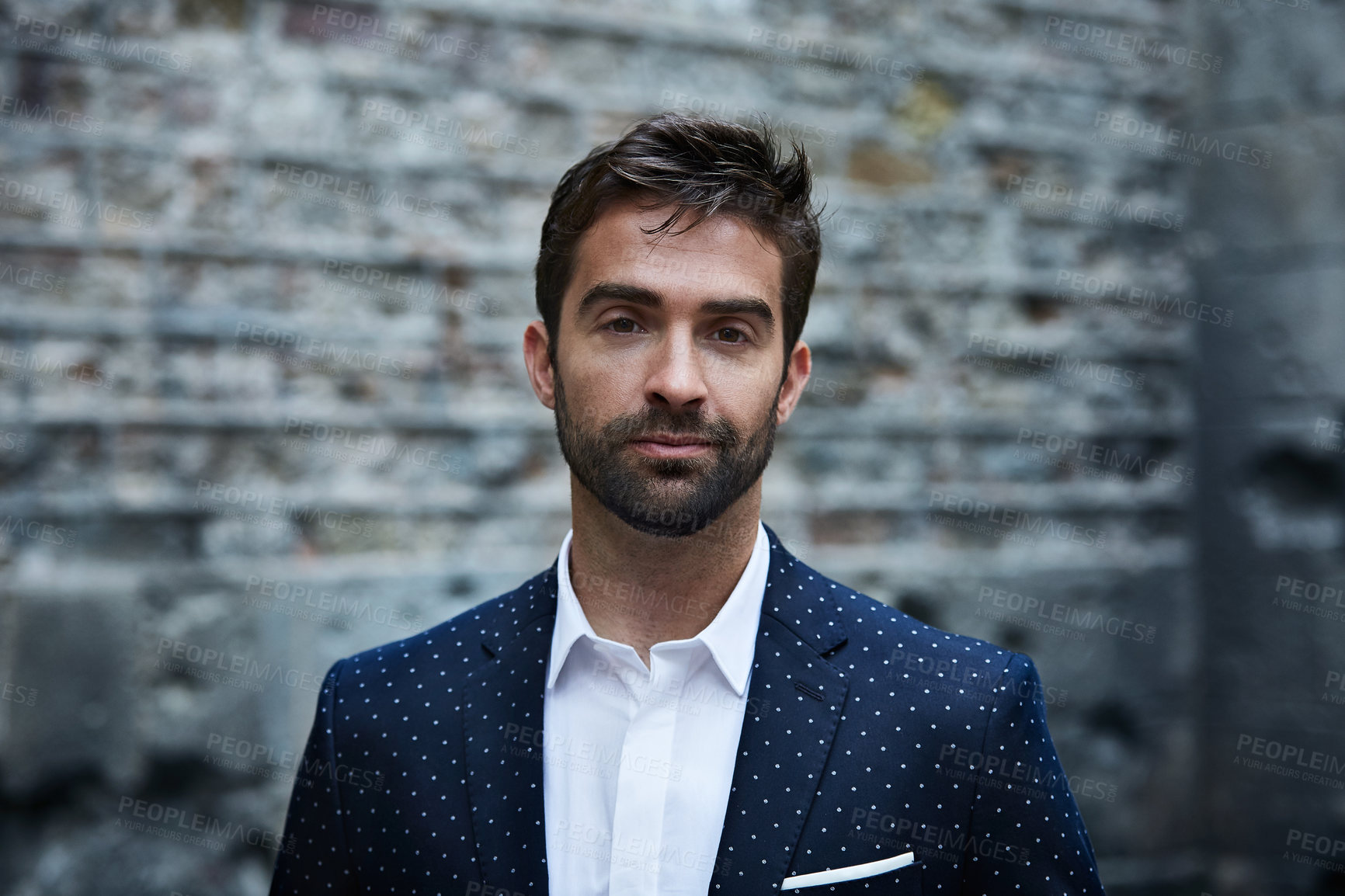 Buy stock photo Cropped portrait of a handsome young businessman standing in an urban alleyway