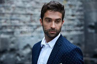 Buy stock photo Cropped shot of a handsome young businessman standing in an urban alleyway