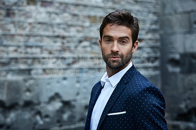 Buy stock photo Cropped portrait of a handsome young businessman standing in an urban alleyway