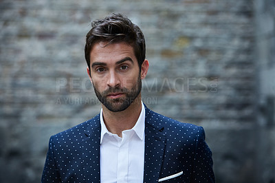 Buy stock photo Cropped portrait of a handsome young businessman standing in an urban alleyway