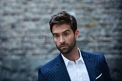 Buy stock photo Cropped shot of a handsome young businessman standing in an urban alleyway