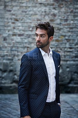 Buy stock photo Cropped shot of a handsome young businessman looking thoughtful while standing in an urban alleyway