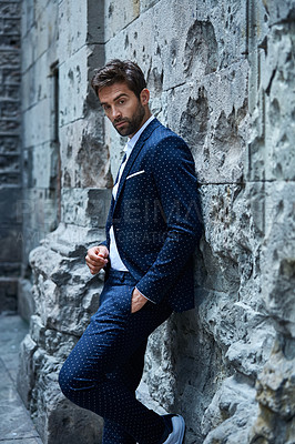 Buy stock photo Cropped shot of a handsome young businessman standing in an urban alleyway
