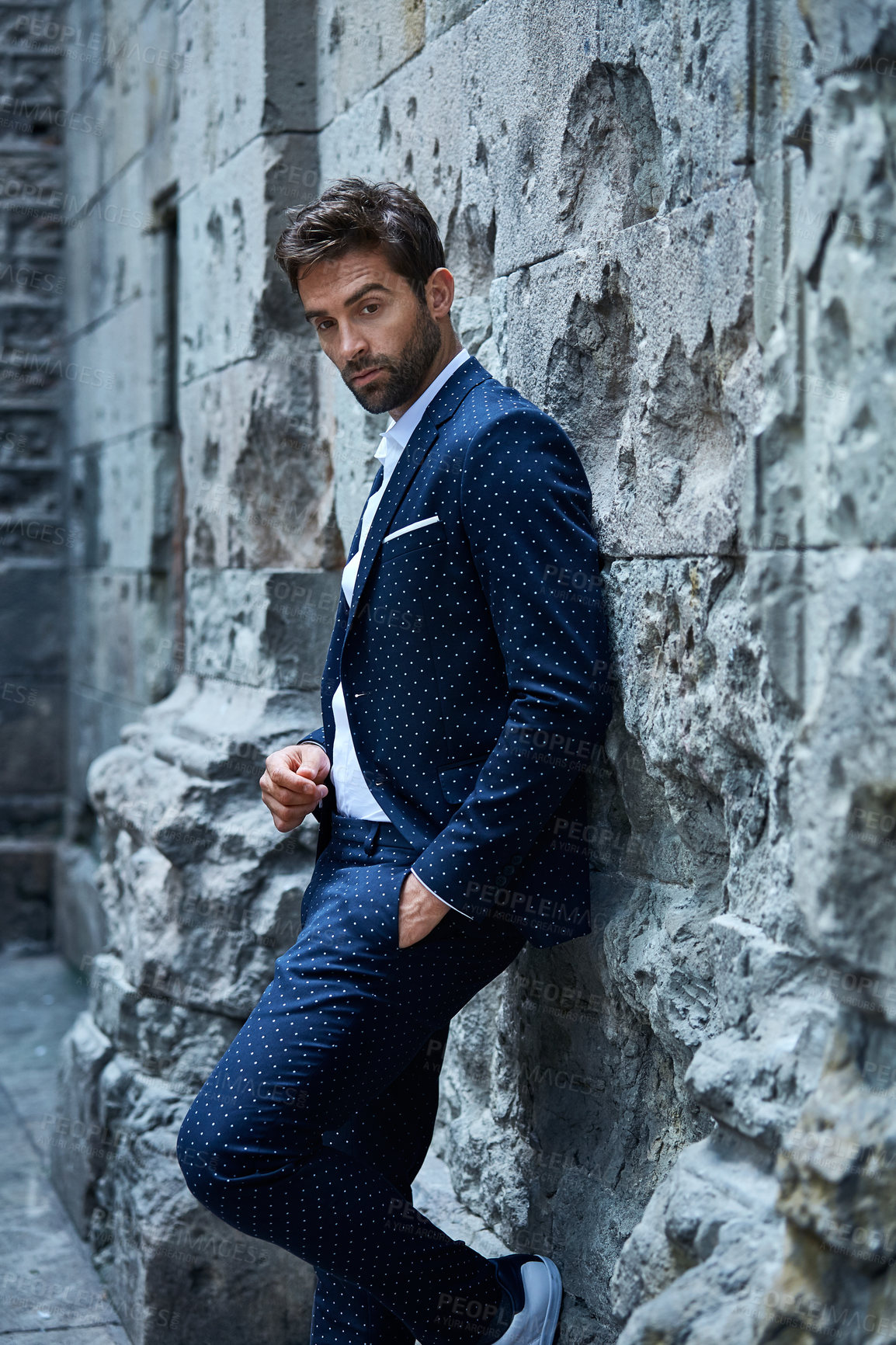 Buy stock photo Cropped shot of a handsome young businessman standing in an urban alleyway