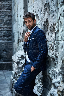 Buy stock photo Cropped shot of a handsome young businessman looking thoughtful while standing in an urban alleyway