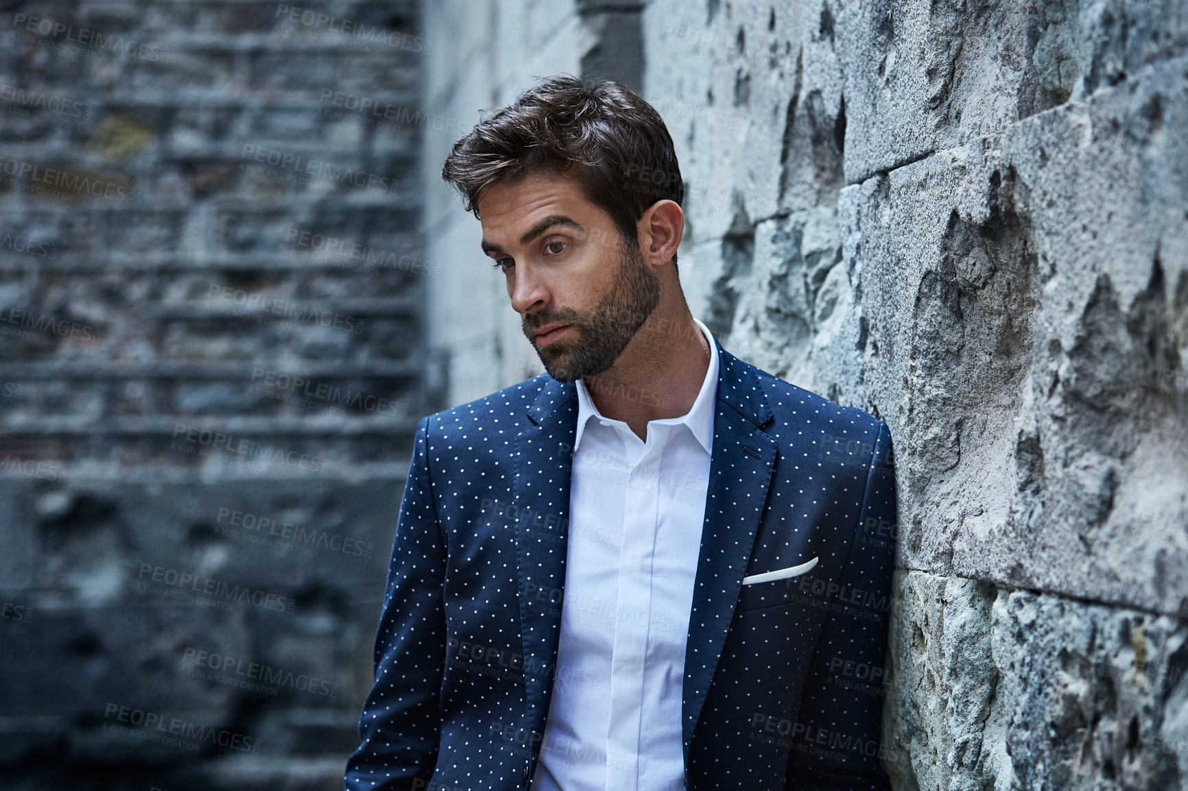 Buy stock photo Thinking, business and man in town for travel, career pride and about us with real estate agent. Serious, male person or realtor at brick wall with vision, morning commute and downtown infrastructure