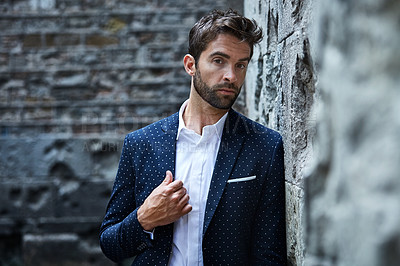 Buy stock photo Cropped shot of a handsome young businessman standing in an urban alleyway
