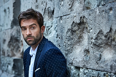 Buy stock photo Cropped shot of a handsome young businessman standing in an urban alleyway