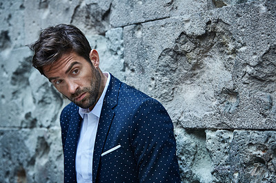 Buy stock photo Cropped shot of a handsome young businessman looking thoughtful while standing in an urban alleyway