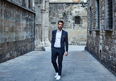 Buy stock photo Full length portrait of a handsome young businessman standing in an urban alleyway