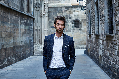 Buy stock photo Cropped portrait of a handsome young businessman standing in an urban alleyway