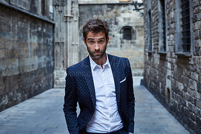 Buy stock photo Cropped portrait of a handsome young businessman standing in an urban alleyway
