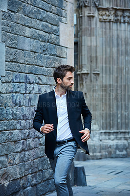 Buy stock photo Cropped shot of a handsome young businessman running through an urban alleyway