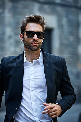 Buy stock photo Cropped shot of a handsome young businessman running through an urban alleyway