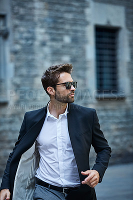 Buy stock photo Cropped shot of a handsome young businessman running through an urban alleyway