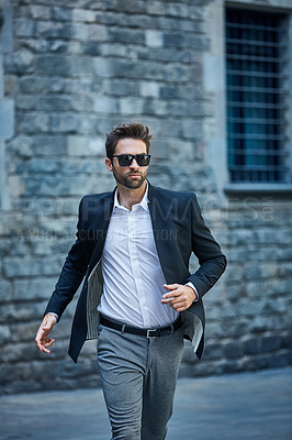 Buy stock photo Cropped shot of a handsome young businessman running through an urban alleyway