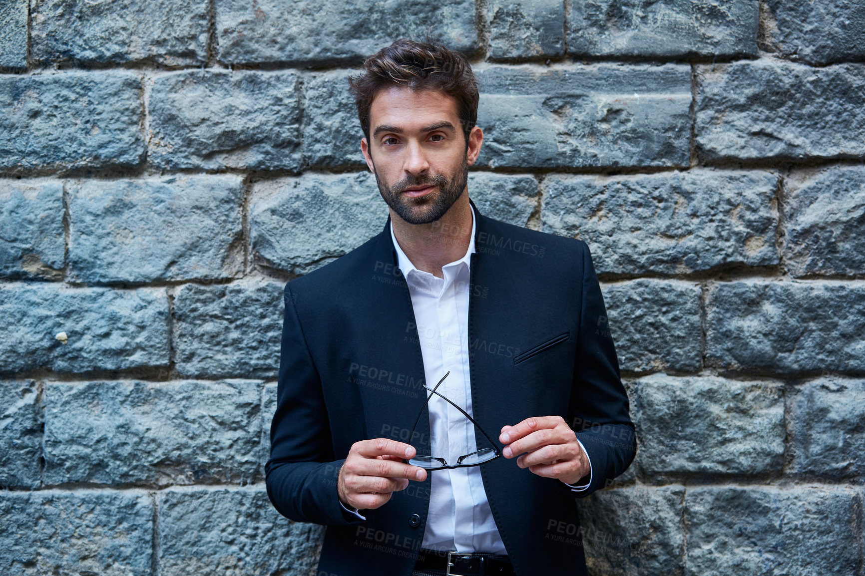 Buy stock photo Pride, realtor or man on wall with portrait, urban developer  or ambition as real estate advisor. Smile, glasses or broker in town with about us, commercial agent or confidence in property management