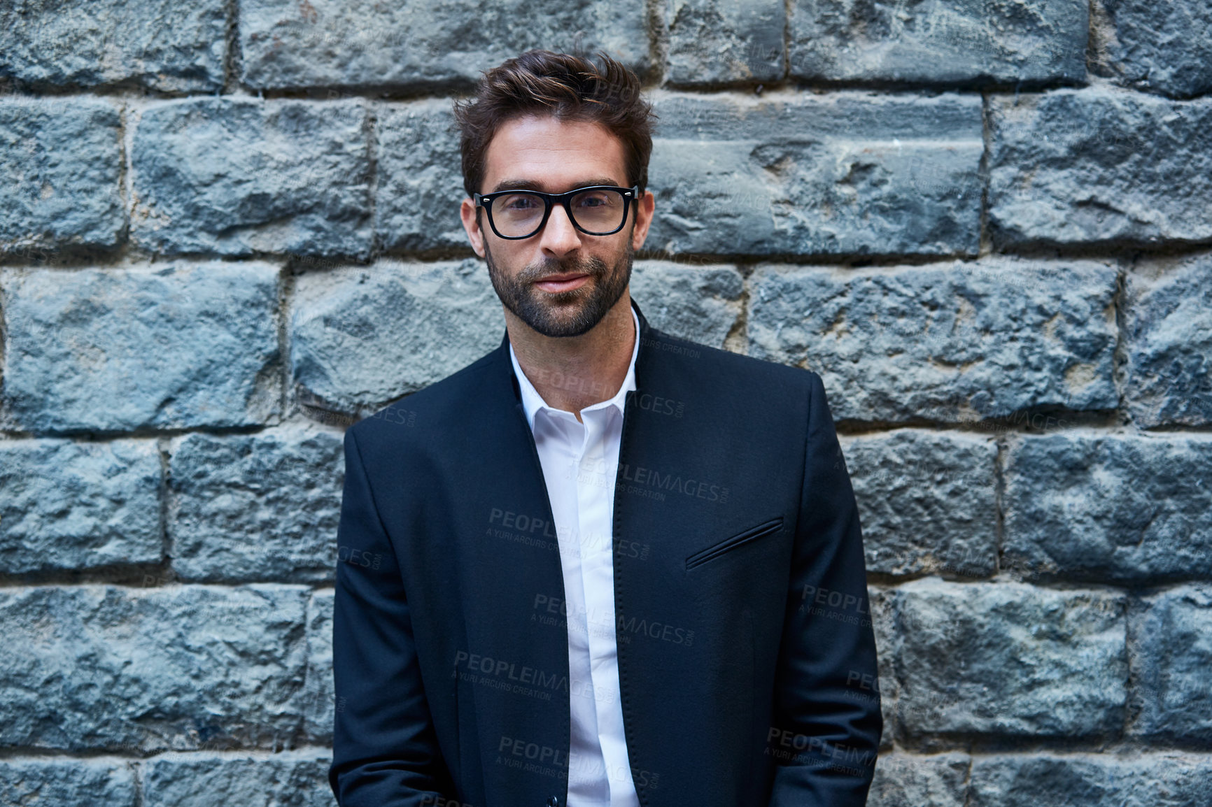 Buy stock photo Glasses, portrait and man by brick wall for business, about us and career development with lawyer. Confident male person, corporate attorney and professional with eyewear, ambition and vision in city