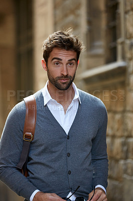 Buy stock photo Cropped shot of a handsome young businessman walking through an urban alleyway