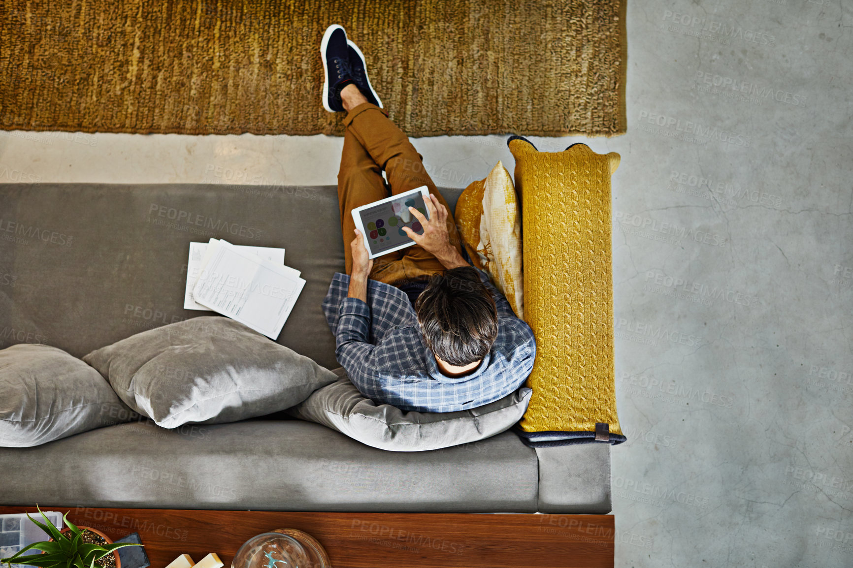 Buy stock photo Tablet, freelancer and above with man in home for research, editing and marketing budget. Review, email list and remote work with person online in living room for proposal, reading and planning