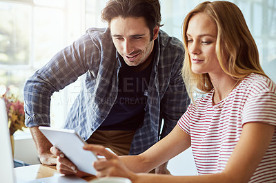 Buy stock photo Cropped shot of a young attractive couple using a tablet together at home
