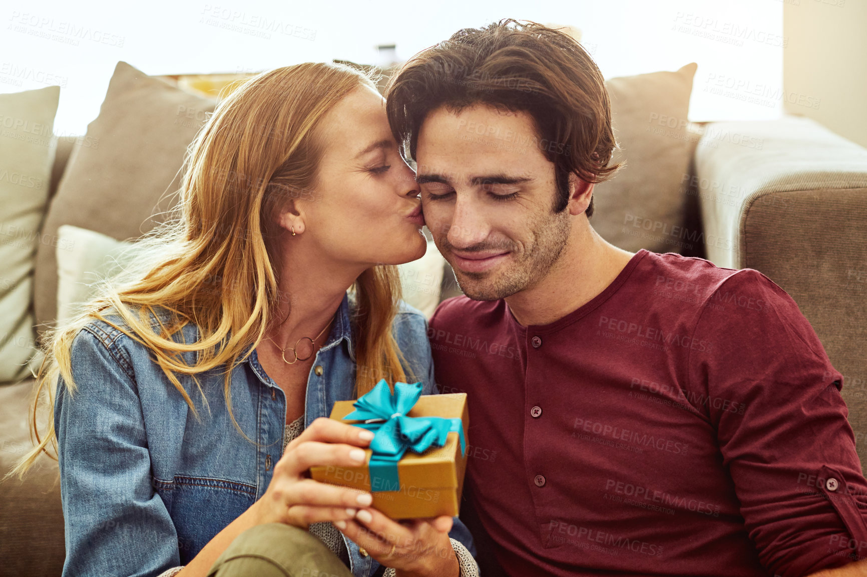 Buy stock photo Birthday, kiss and couple in home with gift for surprise, giving present and celebrate milestone. Excited, marriage and man with woman with gesture for loving relationship, support or valentines day