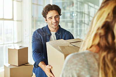 Buy stock photo Shot of a young couple moving into their new home