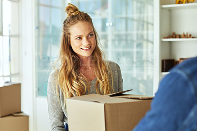 Buy stock photo Shot of a young couple moving into their new home