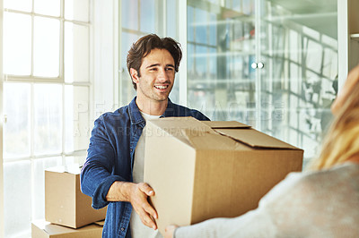Buy stock photo Shot of a young couple moving into their new home