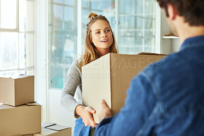 Buy stock photo Shot of a young couple moving into their new home