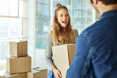 Buy stock photo Shot of a young couple moving into their new home