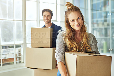 Buy stock photo Shot of a young couple moving into their new home