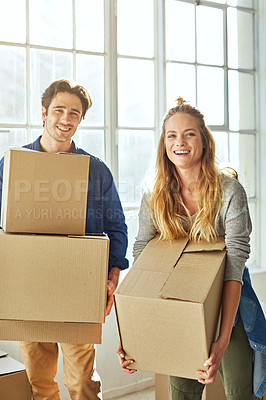 Buy stock photo Shot of a young couple moving into their new home
