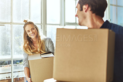 Buy stock photo Shot of a young couple moving into their new home