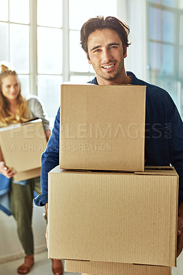 Buy stock photo Shot of a young couple moving into their new home
