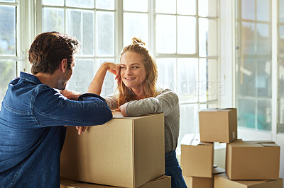 Buy stock photo Shot of a young couple moving into their new home
